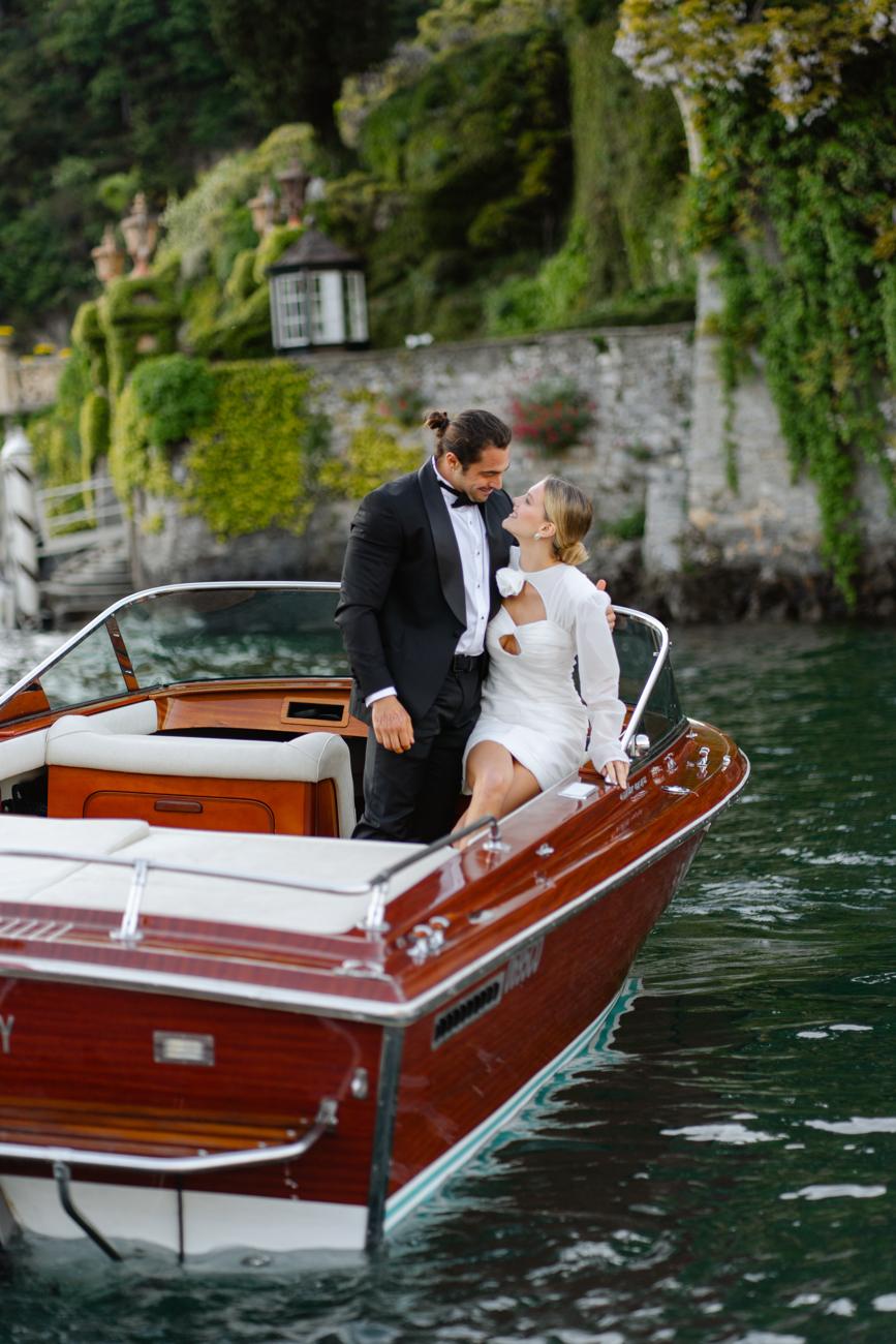 Couple crossing the lake in a wooden boat